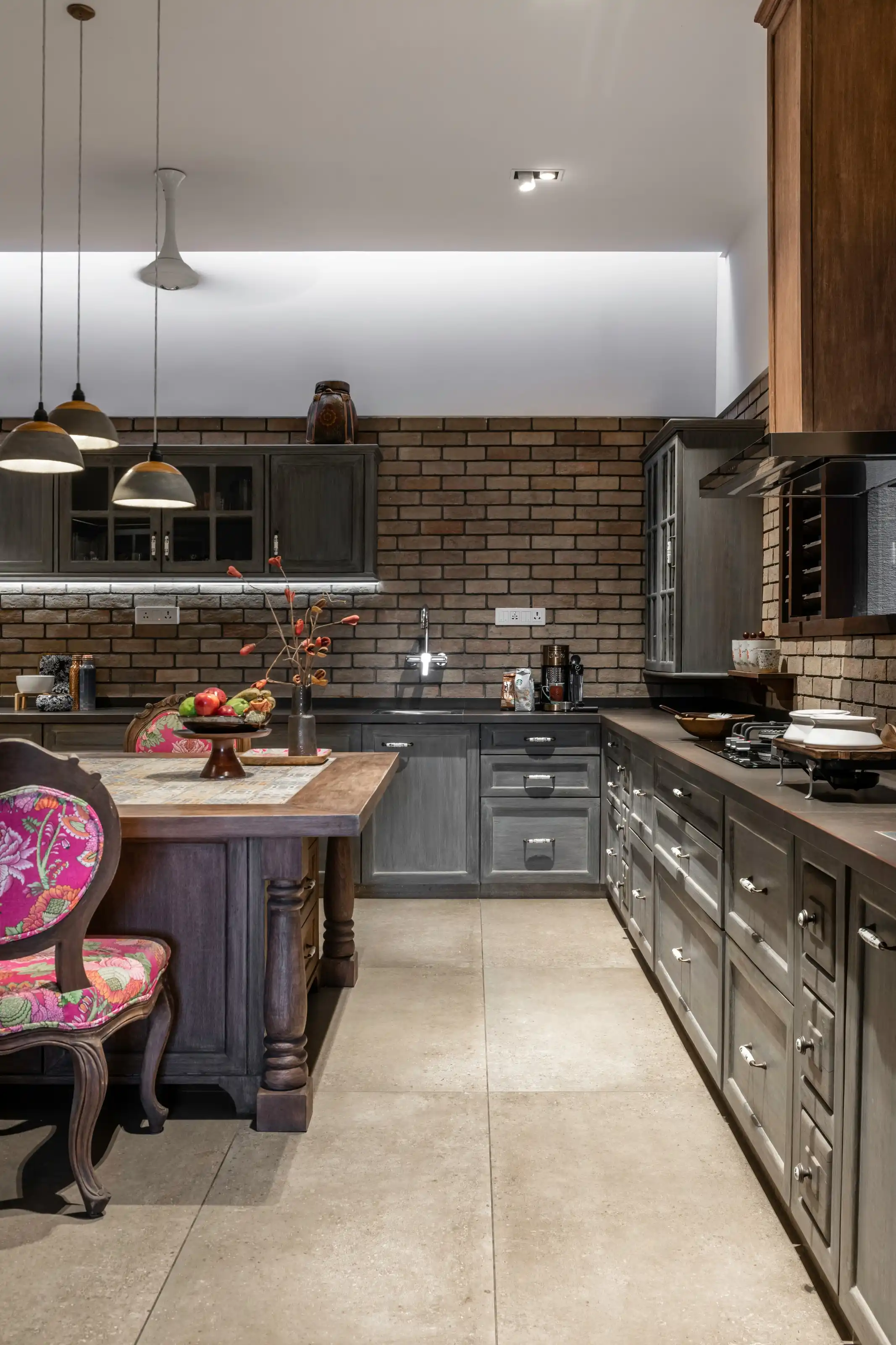 Dark timber joinery against exposed brick in the kitchen