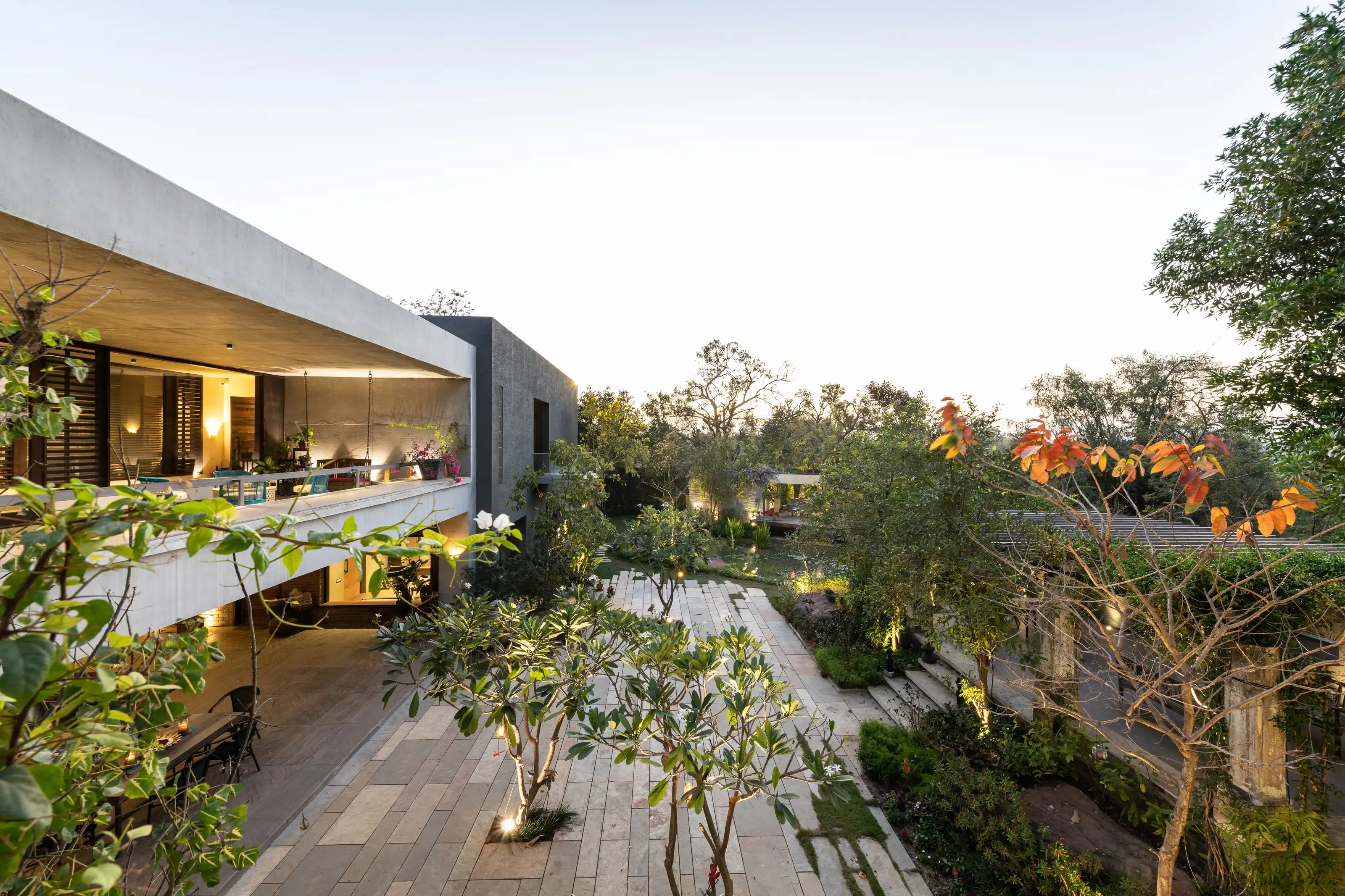 Family living space drawn as one connected sequence beneath exposed concrete